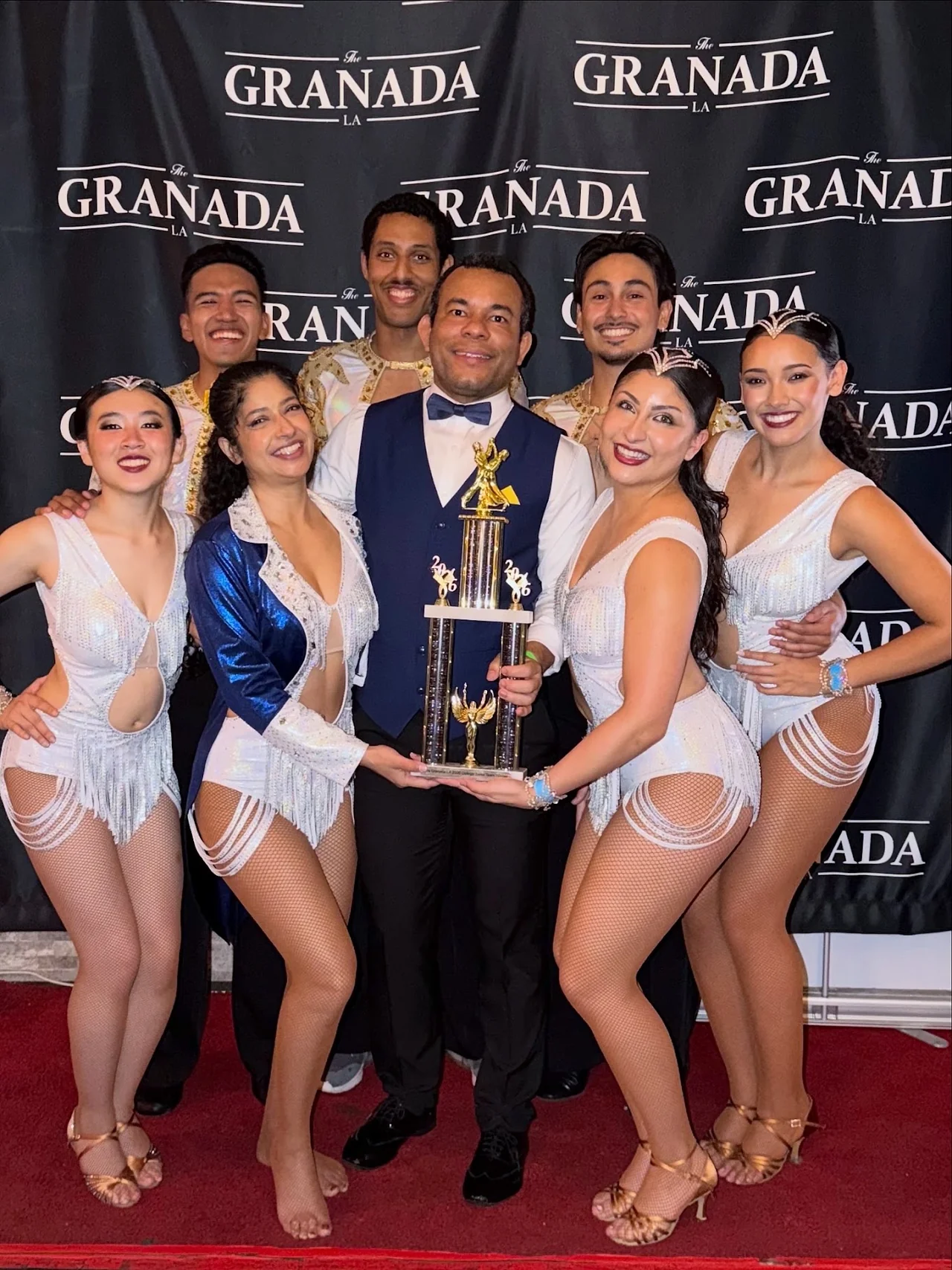 Takeshi Young holding a trophy with his salsa team at The Granada LA