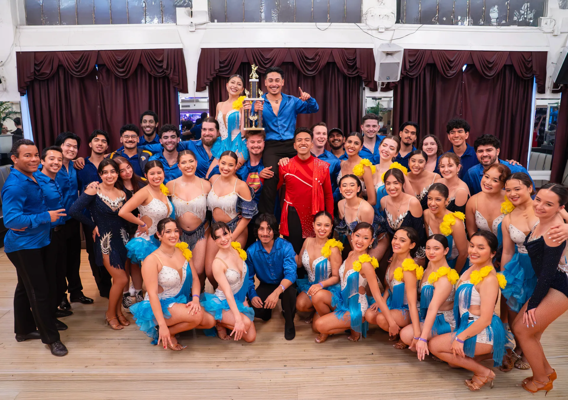 Takeshi Young celebrating with a large salsa performance team